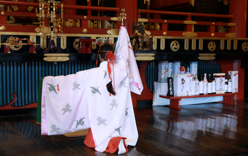 A shrine maiden dancing Kagura (Shinto music and dancing) at the main shrine of Yasaka Shrine